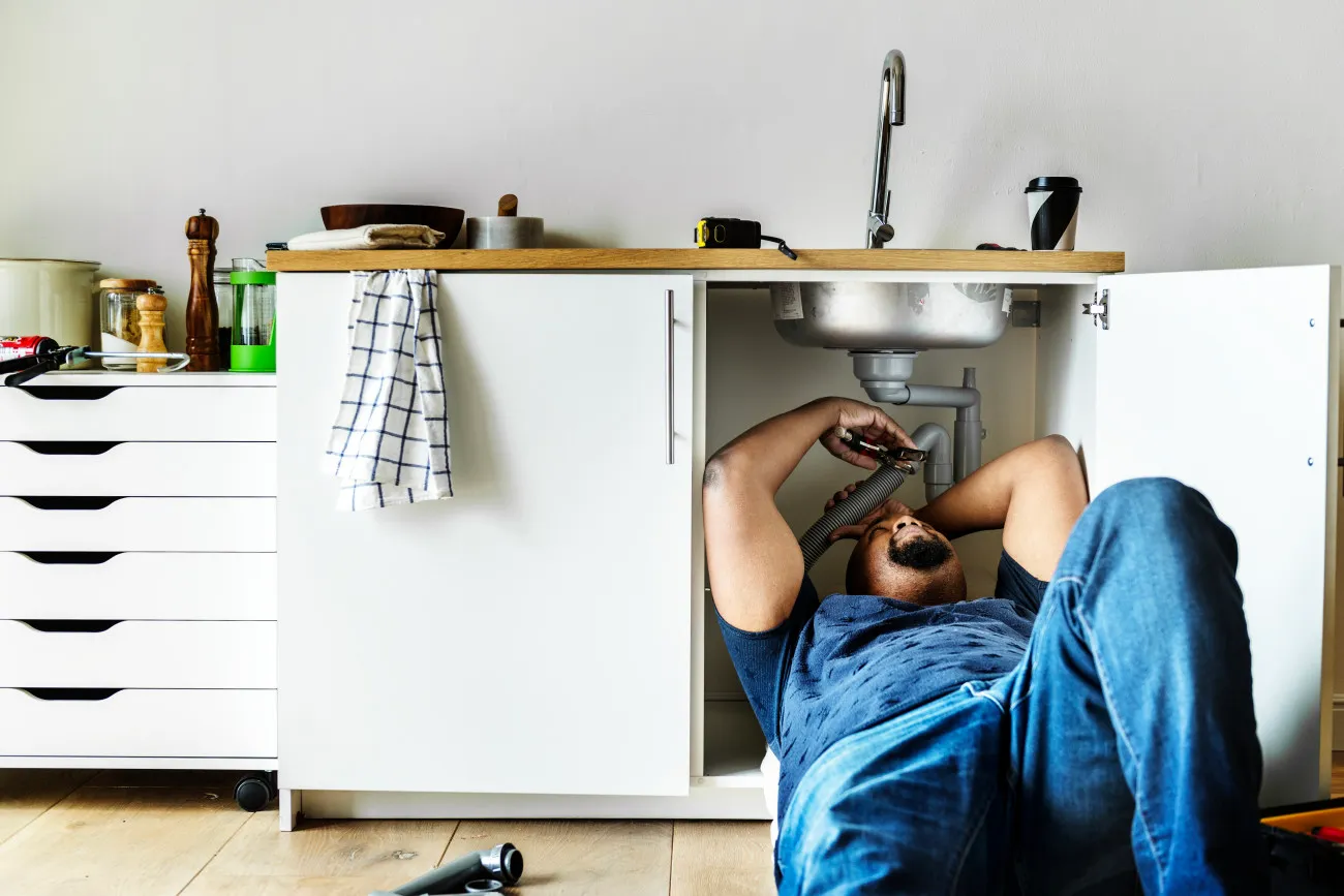 A Plumber fixing a sink