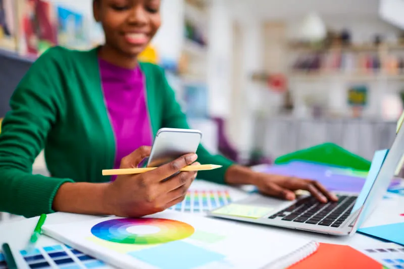 A women at a desk on her phone